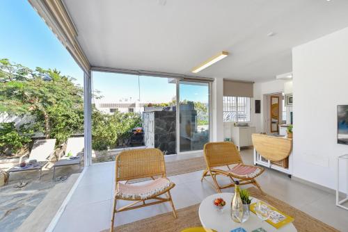 a living room with two chairs and a table at Apartment La Maresia CB9A by VillaGranCanaria in San Agustin