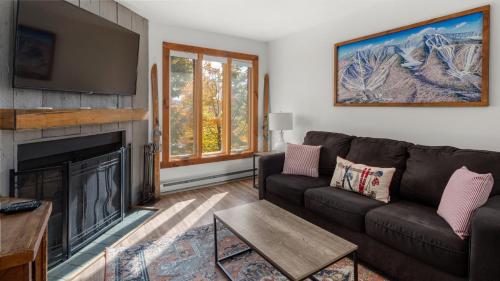 a living room with a couch and a fireplace at 57 North Lynx Condo Condo in Warren