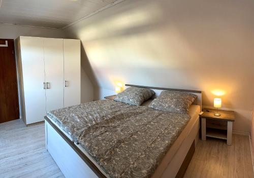 a bedroom with a bed with two pillows on it at Ferienwohnung Greier in Neuenkirchen