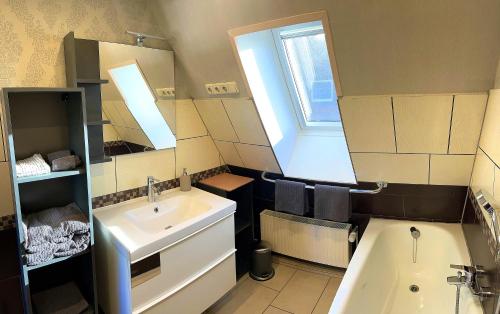 a bathroom with a sink and a mirror at Ferienwohnung Greier in Neuenkirchen