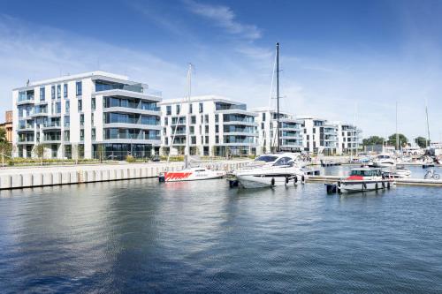 a group of boats docked in a harbor with buildings at Apartament Faltom Marina Gdynia in Gdynia