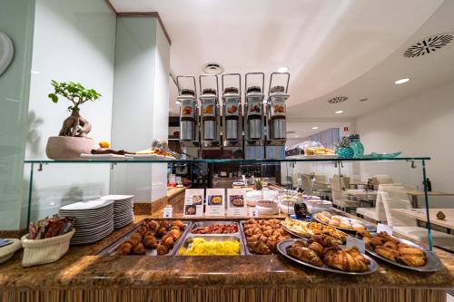 a buffet line with many different types of food at Hotel Palma de Majorca in Bibione