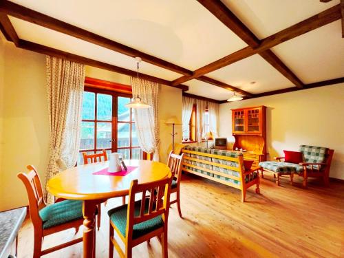 a living room with a table and chairs and a couch at Ferienwohnung Südblick in Bad Kleinkirchheim