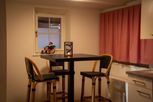 a kitchen with a table and chairs and a window at Uncle Eric's Chalet in Matten