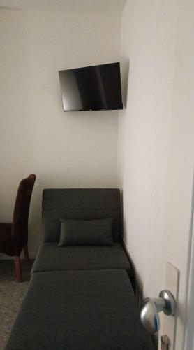 a bedroom with a bed and a flat screen tv on the wall at b & b ultimo miglio in Treviso