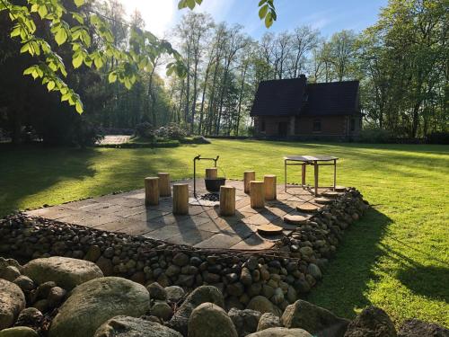 a fire pit in the middle of a yard at Mednieku Namiņš in Sigulda