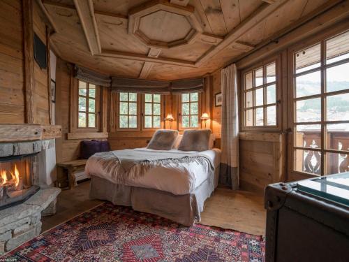 a bedroom with a bed and a fireplace at Luxueux Duplex 4* avec parking privé au cœur de Courchevel 1850 - FR-1-575-15 in Courchevel