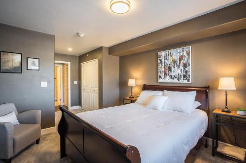 a bedroom with a large bed and a chair at First Tracks 3303 Condo in Steamboat Springs