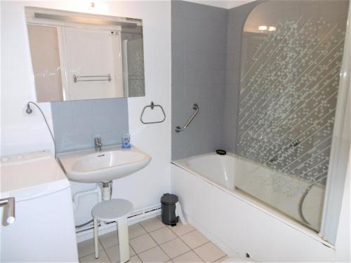a bathroom with a sink and a bath tub and a sink at Appartement Morvan in Sarzeau