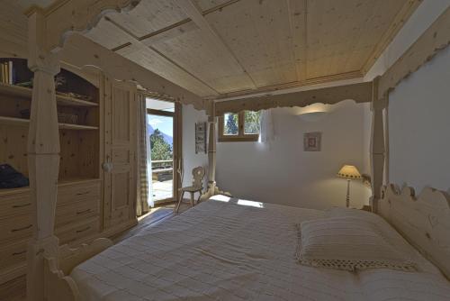 a bedroom with a large bed and a window at Chesa Sur Puoz 15 - Samedan in Samedan