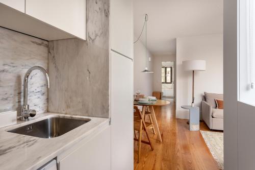 een keuken met een wastafel en een woonkamer bij ALTIDO Vitoria apartments near the Cathedral in Porto