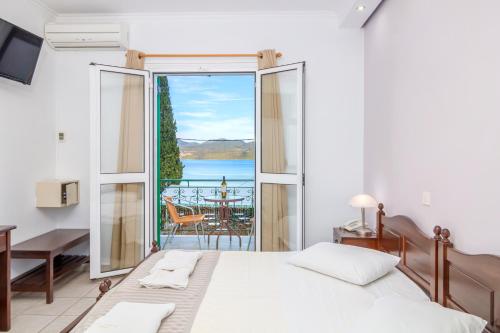 a bedroom with a bed and a view of the ocean at Vergina Star Hotel in Nikiana