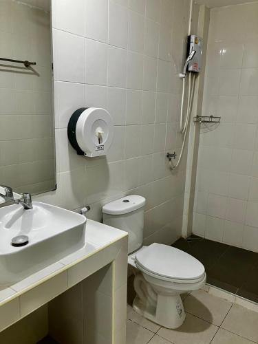 La salle de bains est pourvue de toilettes, d'un lavabo et d'un miroir. dans l'établissement บ้านพักสำหรับ 10 ท่าน, à Udon Thani