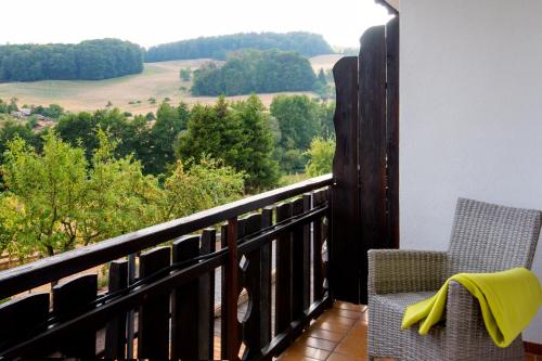 a balcony with a view of a field and trees at Landhotel Lortz in Reichelsheim
