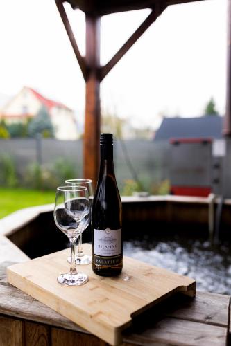 a bottle of wine and a glass on a table at Rodzinny apartament FOLKER in Węgierska Górka