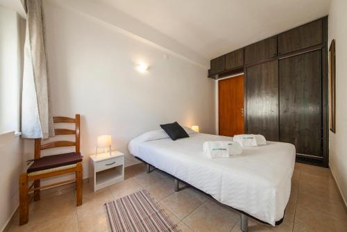 um quarto com duas camas e uma cadeira. em Rising Sun Apartments em Lagos