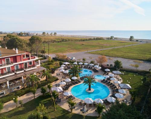 an aerial view of a resort with a pool and umbrellas at Mediterranean Princess- Adults Only in Paralia Katerinis