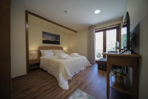 pokój hotelowy z łóżkiem i oknem w obiekcie Casa da Fonte - Gerês w mieście Geres