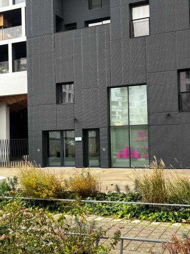 a black building with windows and plants in front of it at @Coloc Gîtes urbains in Nantes