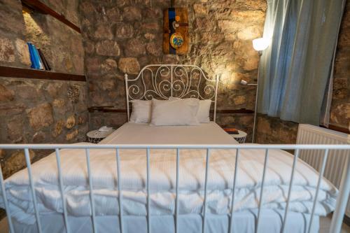 a bed in a room with a stone wall at Hich Hotel Konya in Konya