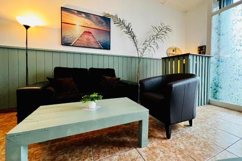 a living room with a couch and a coffee table at El jardin de Iris in Santa Cruz de Tenerife