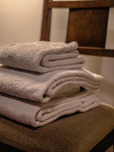 a stack of towels sitting on top of a chair at Casa da Terra Nova - Gerês in Rio Caldo