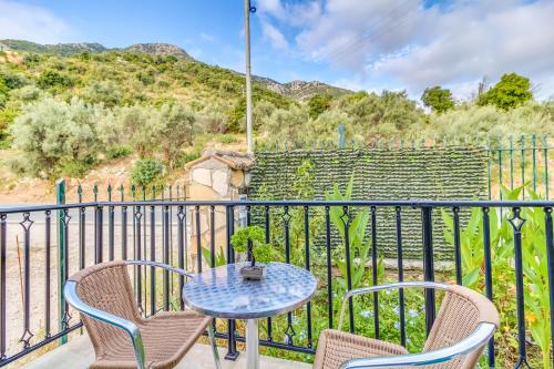 a patio with a table and chairs on a balcony at Vergina Star Hotel in Nikiana