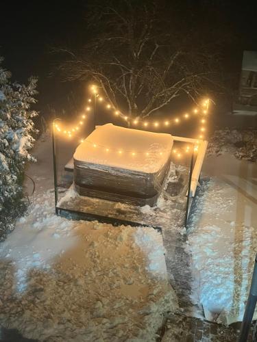 a bed covered in snow with lights on it at MátraForRest in Mátraszentistván