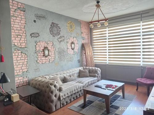 a living room with a couch and a brick wall at Beşiktaş Meydan in Istanbul