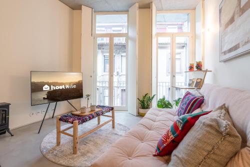 a living room with a couch and a tv at Host Wise - Luxurious Private Flats - Balcony in Porto