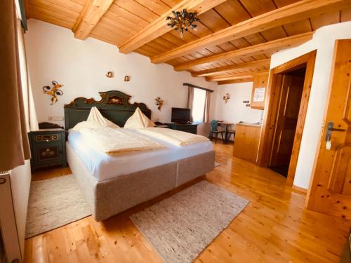 a bedroom with a bed in a room with wooden ceilings at Wengerhof "Urlaub im Gasteinertal" in Dorfgastein