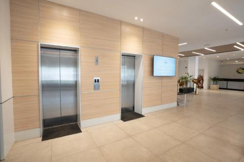 a lobby with three elevators in a building at Sarova Imperial Hotel in Kisumu