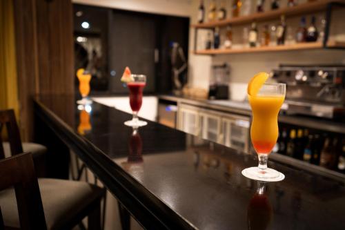 a bar with two cocktails on a counter at Sarova Imperial Hotel in Kisumu