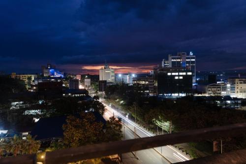 a view of a city at night with lights at Sarova Imperial Hotel in Kisumu