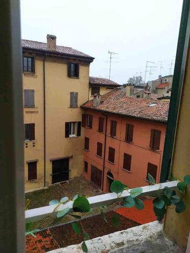 a view of two buildings from a window at Casa Alberti in Mantova