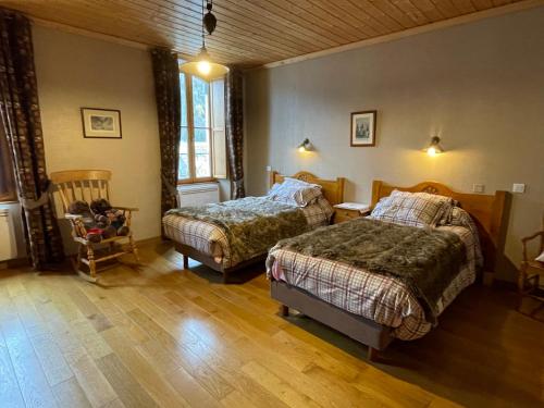 une chambre avec deux lits et un parquet dans l'établissement Appartement 110m2, lits faits linge fourni, plein centre, WIFI, à Cauterets
