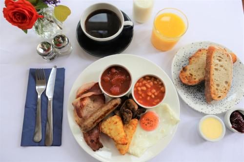 a table with a plate of breakfast food with toast and beans at The Waves in Scarborough