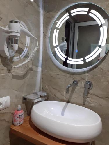 a bathroom with a white sink and a mirror at Vila Lida in Sarandë