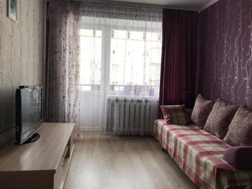 a living room with a couch and a window at Elena in Rivne