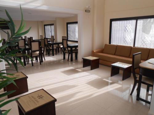 a living room with a couch and tables and chairs at Al Akhawayn in Oujda