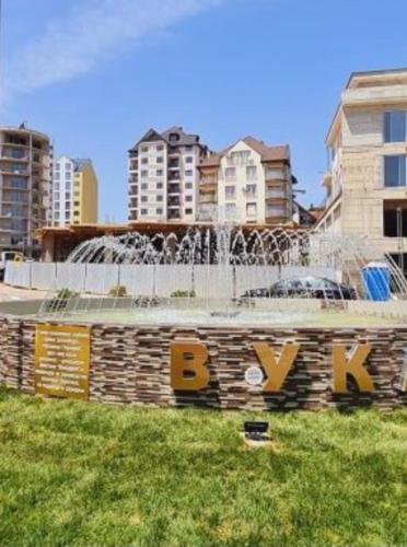 a fountain in the middle of a city with buildings at Apartman Stojanovic 1 in Zlatibor