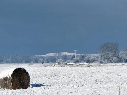 a bale of hay in a snow covered field at Z Widokiem na Wydmę in Łokciowe