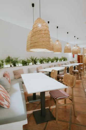 a row of tables and chairs in a restaurant at Boutique Hotel El Tio Kiko in Agua Amarga