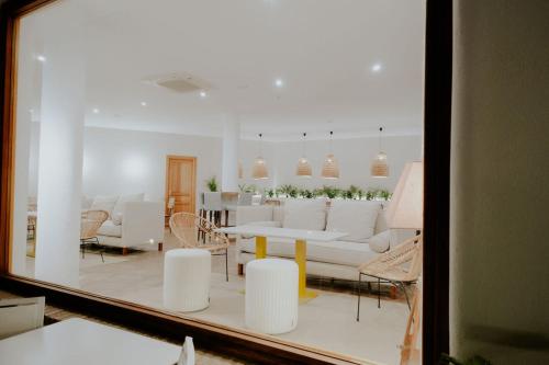 a living room with a white couch and chairs at Boutique Hotel El Tio Kiko in Agua Amarga