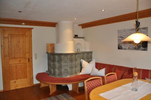 a dining room with a table and a fireplace at Kasperbauer in Kirchberg in Tirol