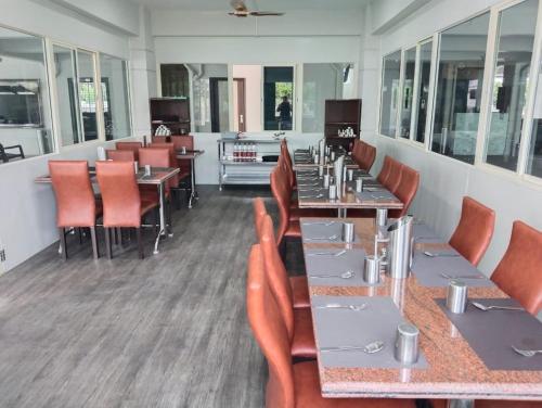 a dining room with tables and chairs in a restaurant at PPH Living KVR Residency in Tada