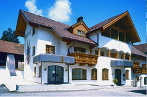 a large white building with a brown roof at Gasthof Genosko in Spiegelau