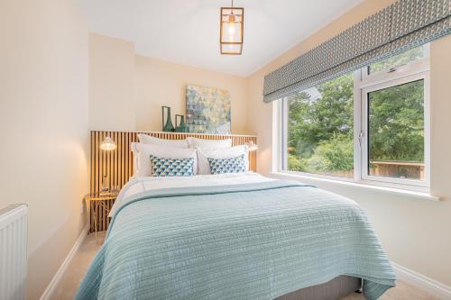 - une chambre avec un lit et une grande fenêtre dans l'établissement The Bank House- Luxury 3 bed cottage with hot tub!, à Silverdale