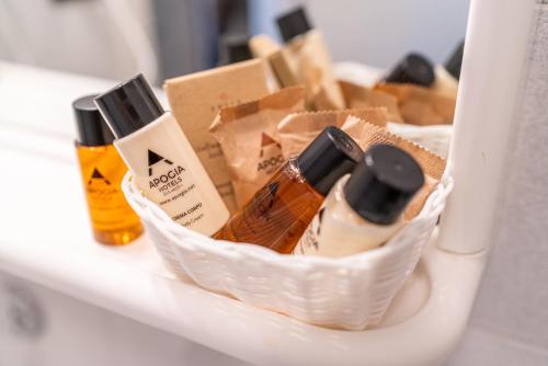 a basket filled with bottles of alcohol on a shelf at Hotel San Giorgio Resort 4S in Caorle