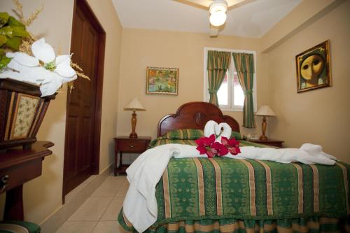 a bedroom with a bed with towels on it at Hotel Discovery in Santo Domingo